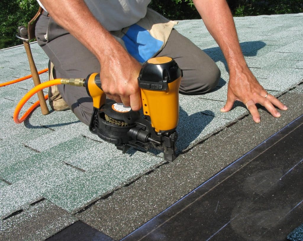 using nail gun to apply asphalt shingles
